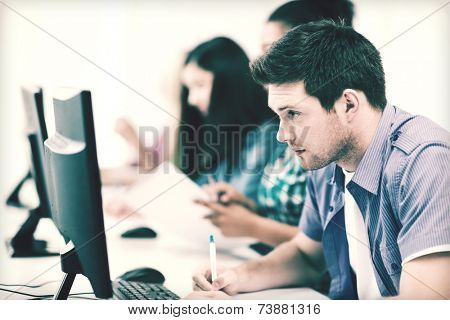 education concept - student with computer studying at school