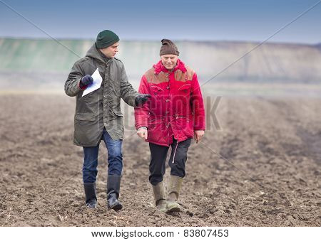 Farmers On Plowed Field