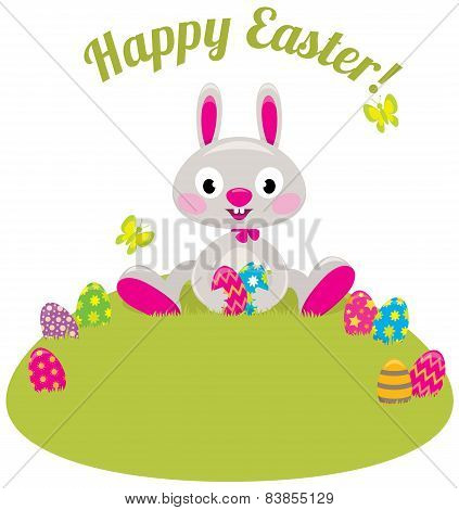 Easter Bunny And Colored Eggs In The Grass