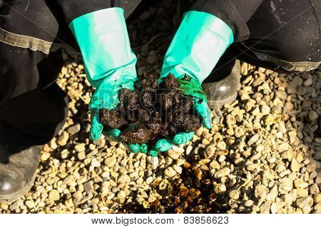 Oil sands development from an oil drilling district. The hand on the oil sands