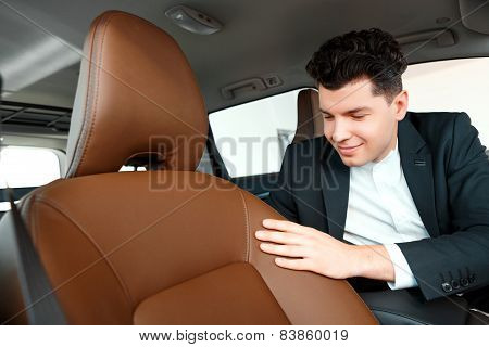 Handsome young man in dealership
