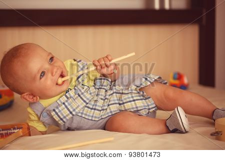 Small Kid Playing With Drum Stick
