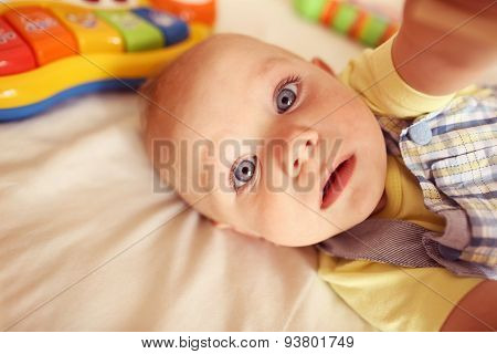 Playful Kid In His Bed
