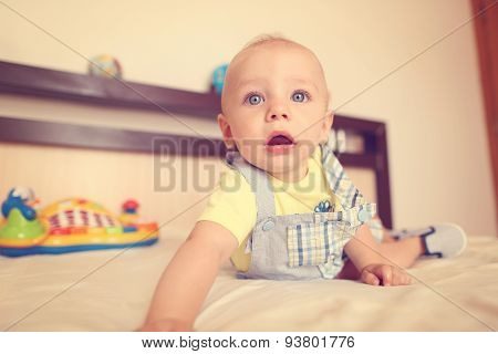 Playful Kid In His Bed