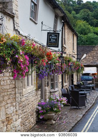 CHIPPENHAM, UK - AUGUST 9, 2014: Castle Combe, unique old English village. Old house and park