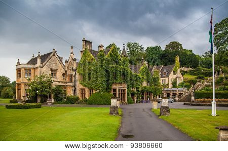 CHIPPENHAM, UK - AUGUST 9, 2014: Castle Combe, unique old English village. Old house and park