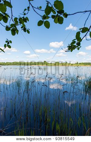 White Clouds On The Blue Sky Over Blue Lake
