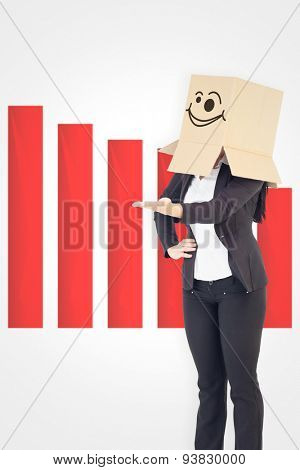 Businesswoman presenting with box over head against wonky smiling face