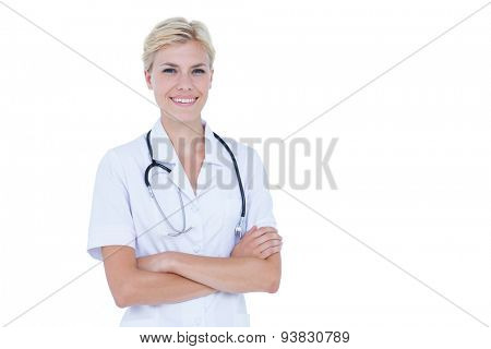 Female doctor folding arms against white background