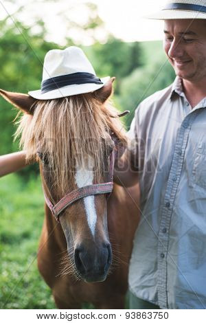 Horse and man in panama hat