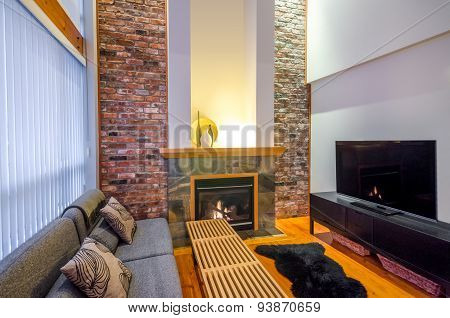 Interior design of a luxury living room with a brick wall and fireplace.