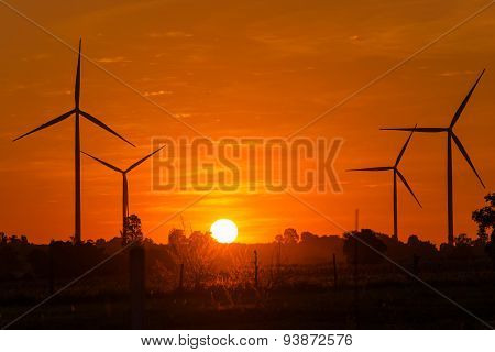 Eco Power In Wind Turbine Farm With Sunset