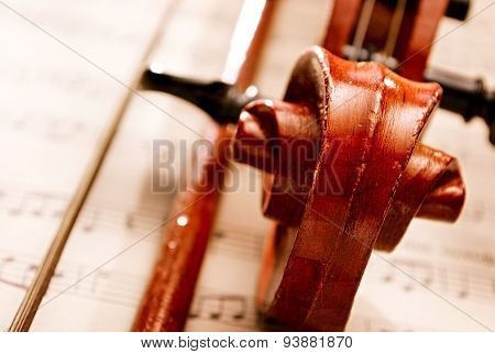 Close Up Of Violin And Bow Resting On Sheet Music
