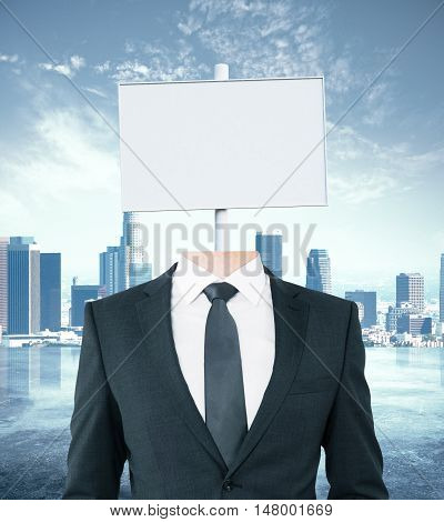 Young businessman body with white signboard instead of head on city background. Mock up