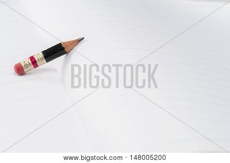 Black Pencil With Pink Eraser On A Paper