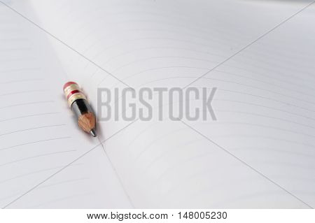 Black Pencil With Pink Eraser On A Paper