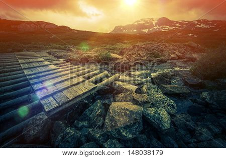 Wooden Trail Bridge and the Norwegian Mountain Landscape. Norway Europe.
