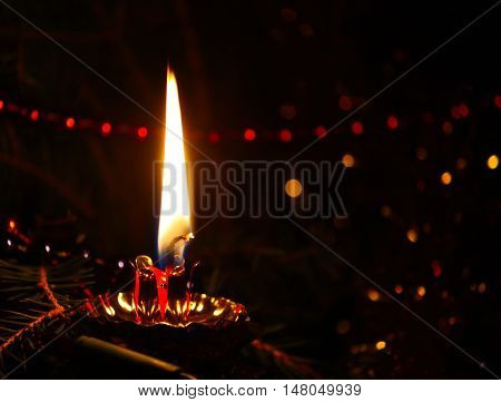 Shot of yellow burning candle on dark background