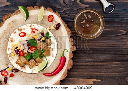Mexican tacos with quinoa salad meat black beans and corn on rustic wooden table. Recipe for Cinco de Mayo party. Top view. Copy space background