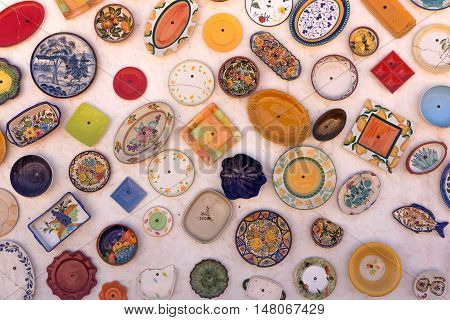 Colorful ceramic plates on the white wall