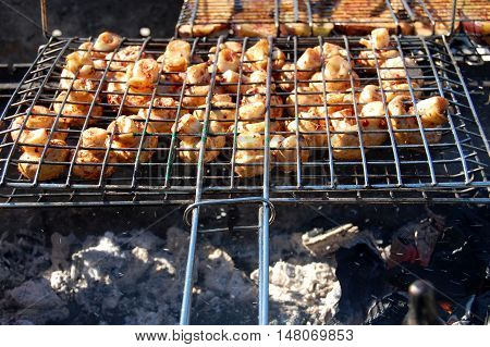 Champignon white mushrooms grilled on grill or BBQ steam. Cooking mushrooms on the grill. Portobello mushrooms marinated and grilled. Grilled vegetables on a grill close up.
