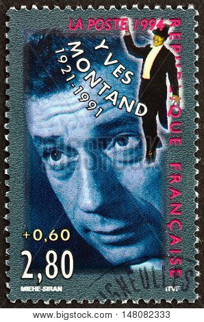 FRANCE - CIRCA 1994: a stamp printed in France shows Yves Montand Italian-French Actor and Singer circa 1994
