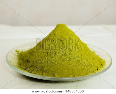 henna powder on sauser close up photo