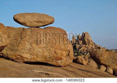 Big balancing granite boulder and mountain in Hampi India. Travel destination in India. Unique landscape. Popular region for bouldering.