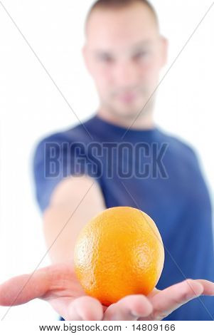 man holding orange in hand