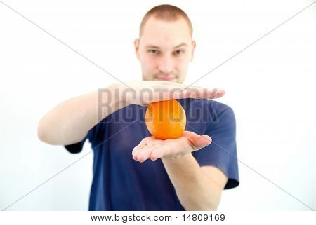 man holding orange in hand
