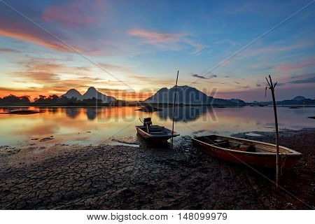 Beautiful Majectic Sunrise By The Lakeside With Fishing Boats. Nature Landscape.
