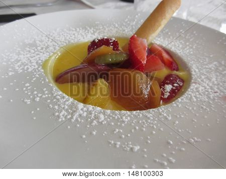 Zabaglione cream with fresh fruit and rolled wafer
