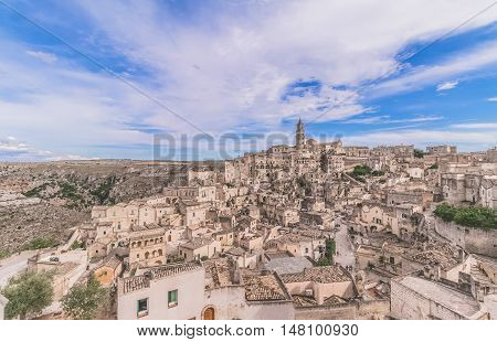 Panoramic View Of Typical Stones (sassi Di Matera) And Church Of Matera Under Blue Sky