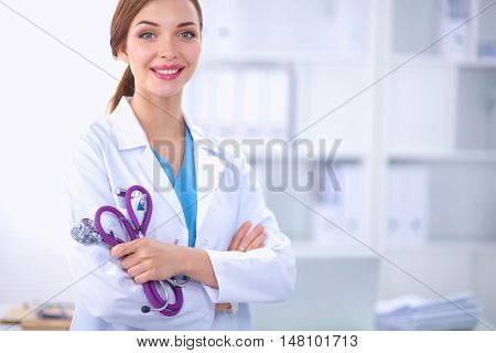 Portrait of happy successful young female doctor holding a stet