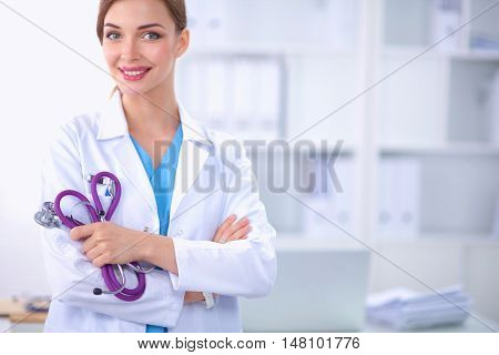 Portrait of happy successful young female doctor holding a stet