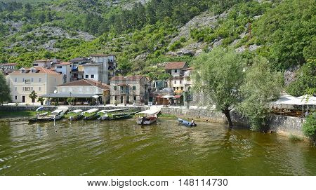 Rijeka Crnojevica Montenegro - June 23rd 2016. Boats line up waiting for tourists to take on tours on Crnojevica River at the start of the tourist season.
