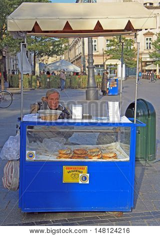 Krakow, Poland - October 29, 2015: woman is selling prezels at street of Krakow, Poland