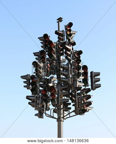 A lot of traffic lights on a blue sky background on a large crossroads