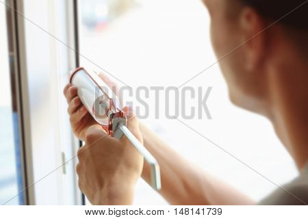 Construction worker installing window in house