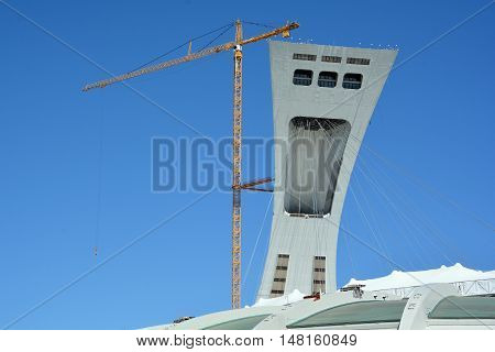 MONTREAL CANADA 09 12 2016. Men repair the Montreal Olympic Stadium tower. It's the tallest inclined tower in the world.Tour Olympique stands 175 meters tall and at a 45-degree angle
