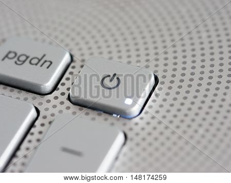 Silver laptop power button close up. Shallow DOF