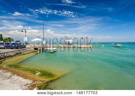 Desenzano, Lombardy, northern Italy, 15th August 2016: Small yachts and boats in harbor of Desenzano del Garda, lake Garda, Italy