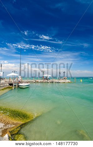 Desenzano, Lombardy, northern Italy, 15th August 2016: Small yachts and boats in harbor of Desenzano del Garda, lake Garda, Italy