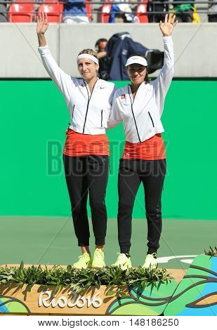 RIO DE JANEIRO, BRAZIL - AUGUST 14, 2016: Silver medalists team Switzerland Timea Bacsinszky (L) and Martina Hingis during medal ceremony after tennis women's doubles final of the Rio 2016 Olympics