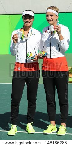 RIO DE JANEIRO, BRAZIL - AUGUST 14, 2016: Silver medalists team Switzerland Timea Bacsinszky (L) and Martina Hingis during medal ceremony after tennis women's doubles final of the Rio 2016 Olympics