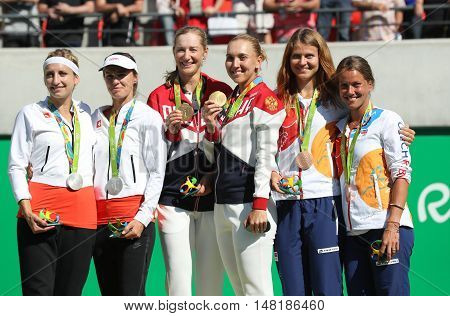 RIO DE JANEIRO, BRAZIL - AUGUST 14, 2016:Tennis women's doubles medalists team Switzerland (L), team Russia and team Czech during medal ceremony of the Rio 2016 Olympic Games at Olympics Tennis Centre