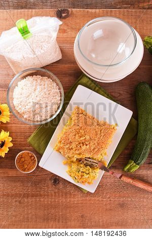 Rice timbale with zucchini on wooden table.