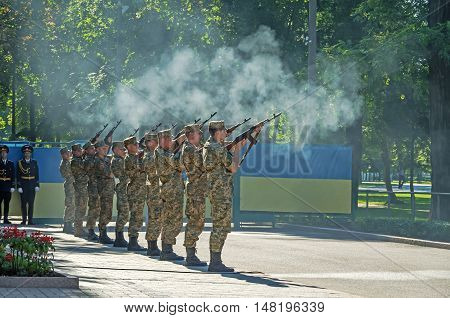 Dnepropetrovsk Ukraine - August 23 2015: Armed forces salute with guns during ceremony of raising Ukrainian national flag