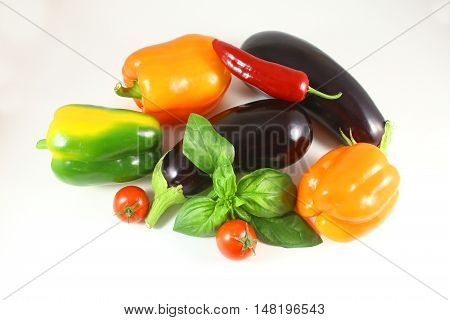 Fresh healthy eggplants chili bell pepper on white background .