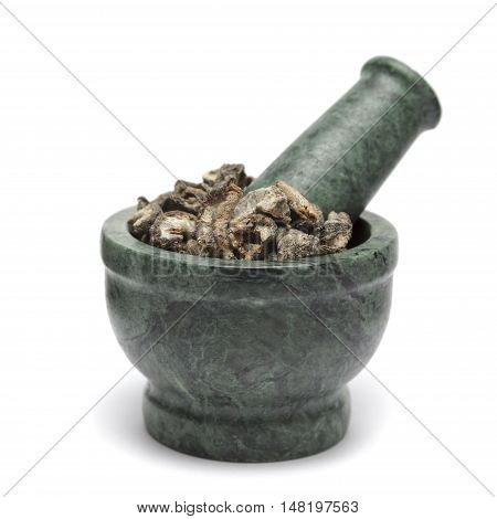 Organic Dried gooseberry or Amla (Ribes grossularia) on marble pestle. Isolated on white background.